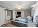 Bedroom with soft lighting, a stylish bed with a tufted bench and an expansive window view at 468 Wilhelm Ne Pl, Concord, NC 28025