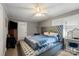 Comfortable bedroom with a blue bed, ceiling fan, natural light and a lovely vanity at 468 Wilhelm Ne Pl, Concord, NC 28025