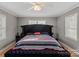 Bright bedroom with a large decorative headboard, and plentiful natural light from large windows at 468 Wilhelm Ne Pl, Concord, NC 28025