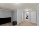 Relaxing room featuring grey walls with a black TV, door and possible access to other bedrooms at 468 Wilhelm Ne Pl, Concord, NC 28025