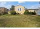 Charming single-story home with a green lawn and light yellow exterior at 468 Wilhelm Ne Pl, Concord, NC 28025