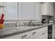 Kitchen featuring granite counters, modern faucet, and stainless under-mount sink at 468 Wilhelm Ne Pl, Concord, NC 28025
