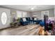 Bright living room features hardwood floors and large windows providing ample natural light at 468 Wilhelm Ne Pl, Concord, NC 28025