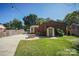 A backyard showcasing a fire pit, green grass, privacy fence, and the exterior of the brick home at 4824 Harcourt Ln, Charlotte, NC 28212