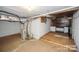 Unfinished basement space shows utility hookups and storage platform at 4824 Harcourt Ln, Charlotte, NC 28212
