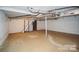 Unfinished basement with concrete floor, visible ductwork and a staircase to the upper level at 4824 Harcourt Ln, Charlotte, NC 28212