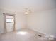 This is a bright bedroom with neutral walls and carpet at 4824 Harcourt Ln, Charlotte, NC 28212