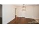 Cozy dining room with hardwood floors, chandelier, and neutral paint at 4824 Harcourt Ln, Charlotte, NC 28212