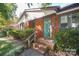 Charming brick home featuring a covered front porch with brick steps and manicured landscaping at 4824 Harcourt Ln, Charlotte, NC 28212