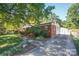 Charming single-story brick home with a well-manicured lawn and mature trees in the front yard at 4824 Harcourt Ln, Charlotte, NC 28212