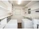 This laundry room has side by side washer and dryer units with lots of shelving at 4824 Harcourt Ln, Charlotte, NC 28212