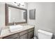 Stylish bathroom featuring granite countertops, a decorative mirror and a toilet at 5007 Sharon Rd # O, Charlotte, NC 28210