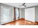 Well-lit room with hardwood floors, a murphy bed and a door to the outside at 5007 Sharon Rd # O, Charlotte, NC 28210