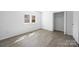 Bright bedroom with a window and closet, featuring modern wood-look flooring at 5015 Forestmont Dr, Matthews, NC 28105