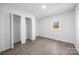Bedroom showcasing a closet, window, and stylish wood-look flooring at 5015 Forestmont Dr, Matthews, NC 28105