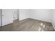 Well-lit bedroom with wood-look flooring and a door leading to an adjacent room at 5015 Forestmont Dr, Matthews, NC 28105