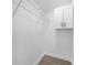 A walk-in closet with modern shelving, a cabinet for storage, and gray wood-look flooring at 5015 Forestmont Dr, Matthews, NC 28105