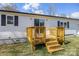 Home exterior featuring a small wooden deck, vinyl siding, and views of the backyard at 5015 Forestmont Dr, Matthews, NC 28105