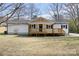 Charming single-story home featuring a covered front porch and well-maintained white siding at 5015 Forestmont Dr, Matthews, NC 28105