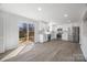 Renovated kitchen leads to deck, featuring white cabinets and new appliances at 5015 Forestmont Dr, Matthews, NC 28105