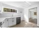Kitchen with modern appliances, white cabinetry, and bright natural light, overlooking another room at 5015 Forestmont Dr, Matthews, NC 28105
