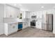 Updated kitchen with stainless steel appliances, quartz countertops, and white cabinetry at 5015 Forestmont Dr, Matthews, NC 28105