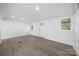 Bright living room with sleek flooring, and fresh white trim at 5015 Forestmont Dr, Matthews, NC 28105