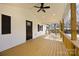 Inviting covered front porch featuring wood floors and white siding, and stylish dark window shutters at 5015 Forestmont Dr, Matthews, NC 28105