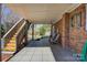 Covered patio with outdoor seating, brick wall, and stairs to deck at 5230 Northview Dr, Hickory, NC 28601