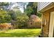 Lush green backyard featuring blooming trees and shrubs, providing a serene and private outdoor space at 5230 Northview Dr, Hickory, NC 28601