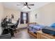 Bedroom with hardwood floors, neutral walls, ceiling fan, window and an ergonomic desk setup at 5230 Northview Dr, Hickory, NC 28601