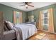 Bedroom with green walls, hardwood floors, ceiling fan, and two windows providing lots of light at 5230 Northview Dr, Hickory, NC 28601