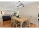 Traditional dining room and partial view into living area with wood floors, light-colored walls, and table with wooden chairs at 5230 Northview Dr, Hickory, NC 28601