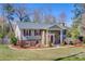 Charming home featuring stone accents, a well-maintained lawn, and red shutters on a sunny day at 5230 Northview Dr, Hickory, NC 28601