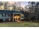 Charming exterior view of a two-story home with stone accents and manicured lawn at dusk at 5230 Northview Dr, Hickory, NC 28601