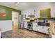 Bright kitchen featuring stainless steel appliances, white cabinetry, butcher block countertops, and adjacent stairs at 5230 Northview Dr, Hickory, NC 28601