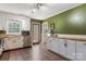 Well-lit kitchen featuring stainless steel appliances, white cabinetry, butcher block countertops and green accent wall at 5230 Northview Dr, Hickory, NC 28601