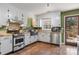 Cozy kitchen featuring stainless steel appliances, white cabinetry, butcher block countertops and a dark sink basin at 5230 Northview Dr, Hickory, NC 28601