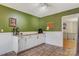 Kitchen area with white lower walls, painted green upper walls, wood counters, tile floor and stainless fridge at 5230 Northview Dr, Hickory, NC 28601