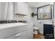 Laundry room with white cabinetry, a window, tile floors, and a washer and dryer at 5230 Northview Dr, Hickory, NC 28601