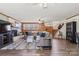 Living room with wood paneling, carpet, fireplace, television, ceiling fan, and staircase at 5230 Northview Dr, Hickory, NC 28601