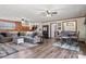 Living room with hardwood floors, fireplace, ceiling fan, staircase, bar area and dining table at 5230 Northview Dr, Hickory, NC 28601