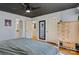 Bright bedroom with view into ensuite bathroom, featuring dark ceiling fan, wood furnishings, and hardwood floors at 5230 Northview Dr, Hickory, NC 28601