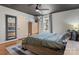 Spacious bedroom with gray and white rug, wood furnishings, and view of a nearby window at 5230 Northview Dr, Hickory, NC 28601