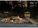 Illuminated landscaped backyard with pond, gazebo, and lush trees at night at 5230 Northview Dr, Hickory, NC 28601