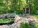 Landscaped backyard with pond, gazebo, statue, and mature trees at 5230 Northview Dr, Hickory, NC 28601