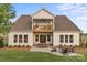 Spacious backyard featuring a stone patio with a fire pit and outdoor seating at 5312 Allburn Pkwy, Concord, NC 28027