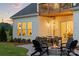 Cozy outdoor patio featuring a stone fire pit with chairs and dining table at 5312 Allburn Pkwy, Concord, NC 28027