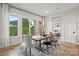 Elegant dining room featuring a rustic table, modern chairs, and large windows showcasing the outdoor scenery at 5312 Allburn Pkwy, Concord, NC 28027