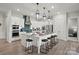 Stunning kitchen with white cabinetry, stainless steel appliances, expansive island, and pendant lighting at 5312 Allburn Pkwy, Concord, NC 28027